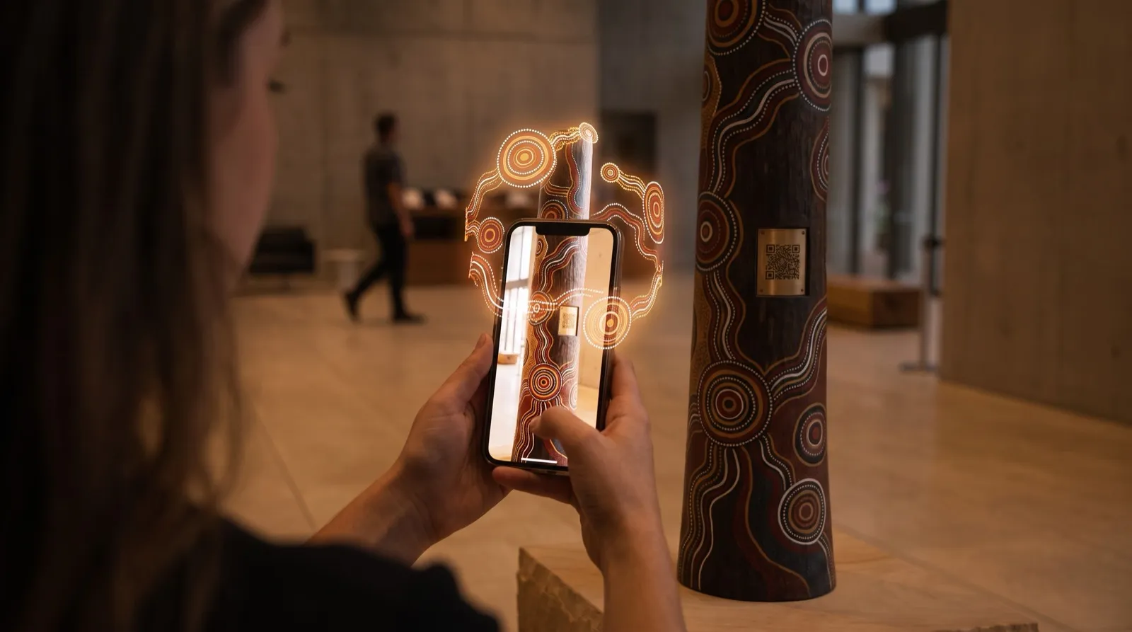 A phone showing an augmented-reality overlay on a CultureStream totem